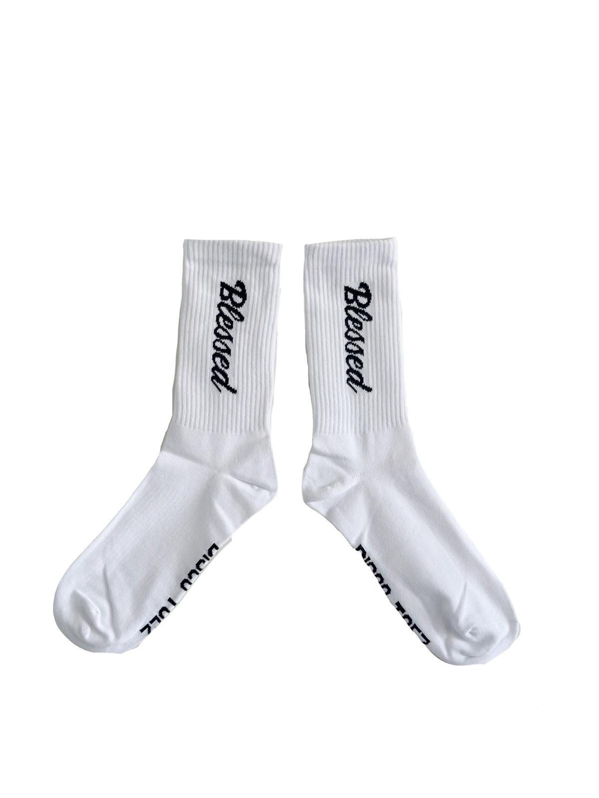 A pair of white socks with black text 'blessed'