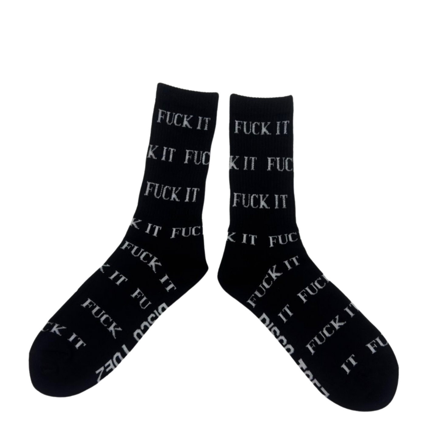 A pair of black socks with white text 'Fuck It' printed all over on a white background