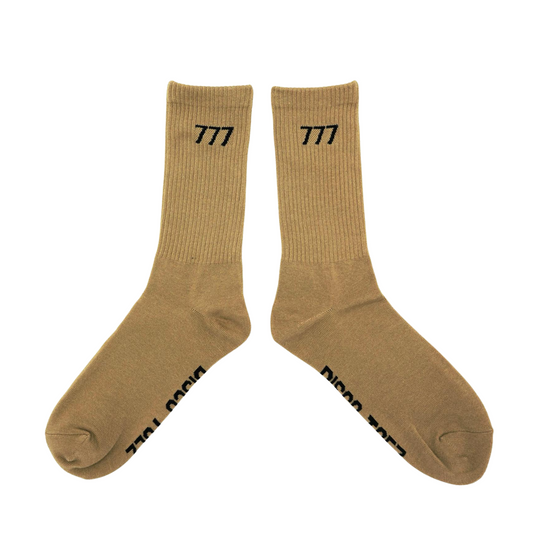 A pair of tan socks with black text '777' on a white background