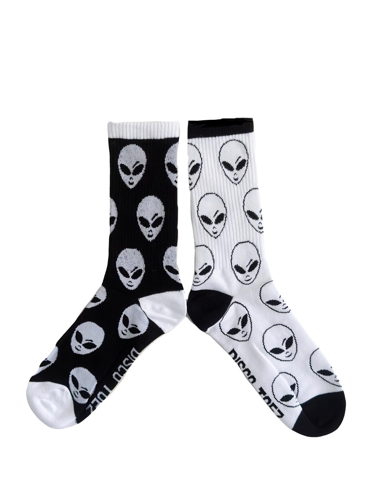 A pair of black and white socks with an alien pattern