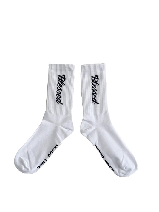 A pair of white socks with black text 'blessed'
