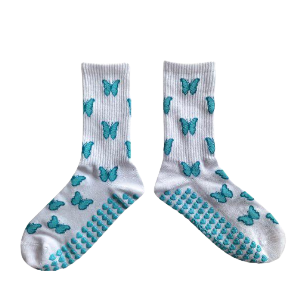White socks with blue butterfly patterns and textured sole on a white background