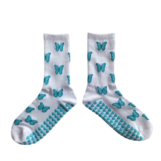 White socks with blue butterfly patterns and textured sole on a white background
