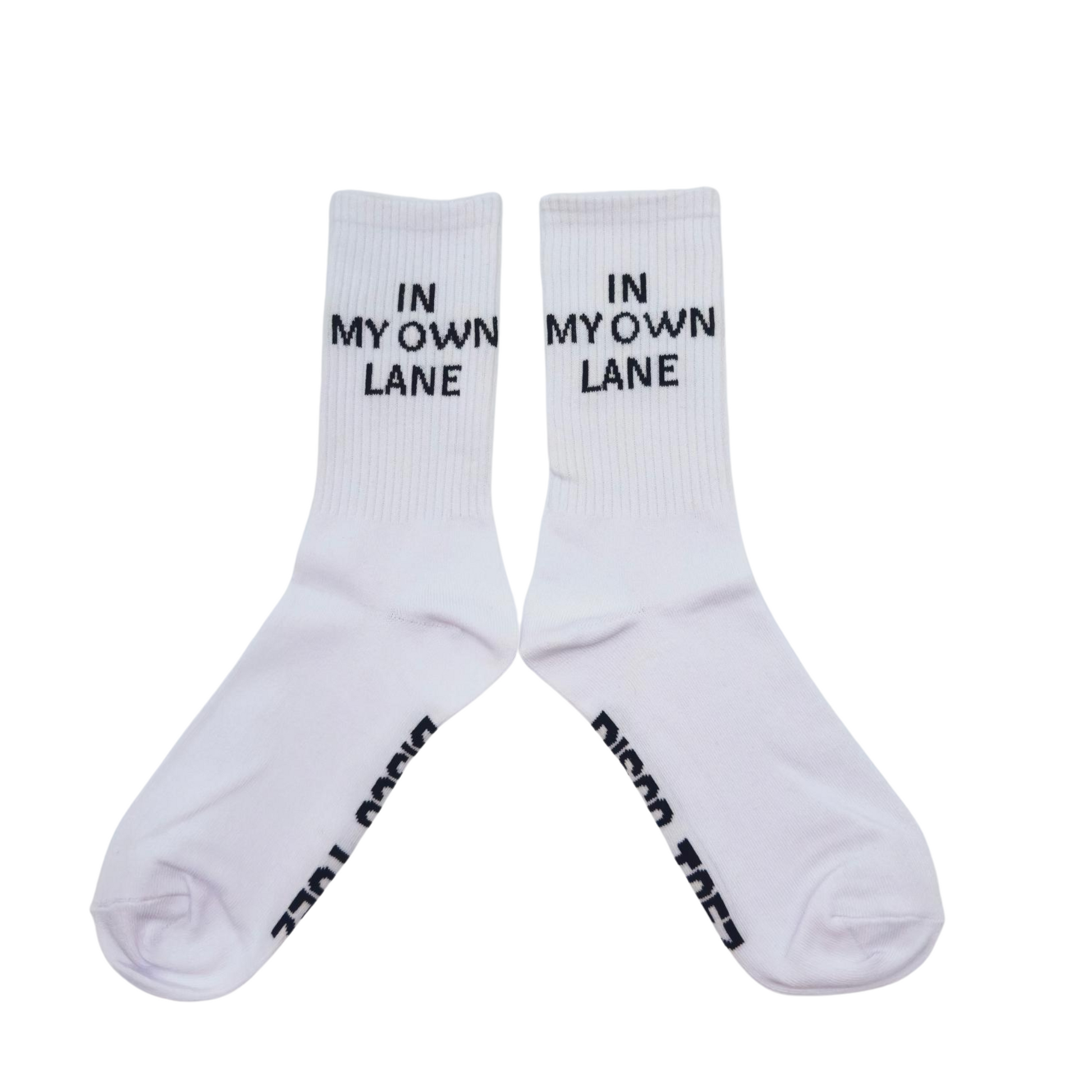 A pair of white socks with black text 'In My Own Lane' on a white background