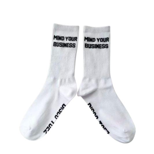 White socks with 'Mind Your Business' text on a white background