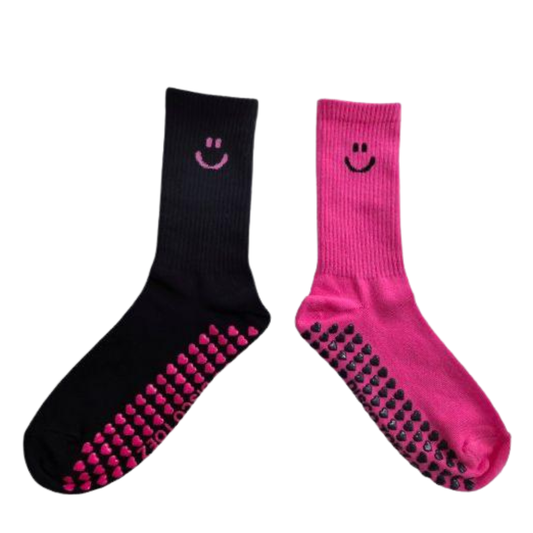 Black and pink socks with smiley face designs on a white background
